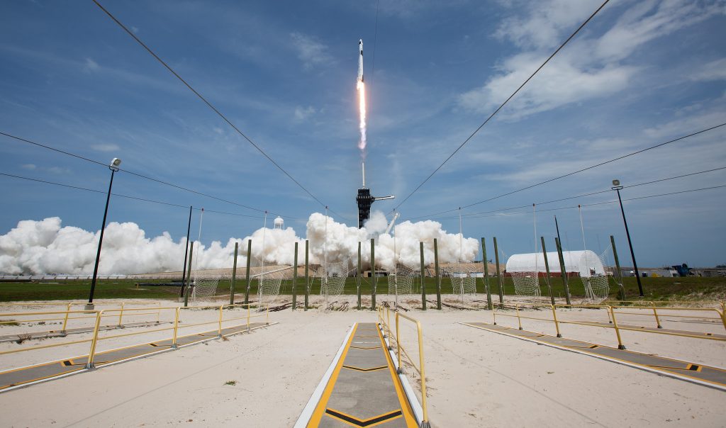 Scientific illustration of a Falcon 9 rocket launch, carrying the Dragon capsule with astronauts to the International Space Station, by NASA/Bill Ingalls