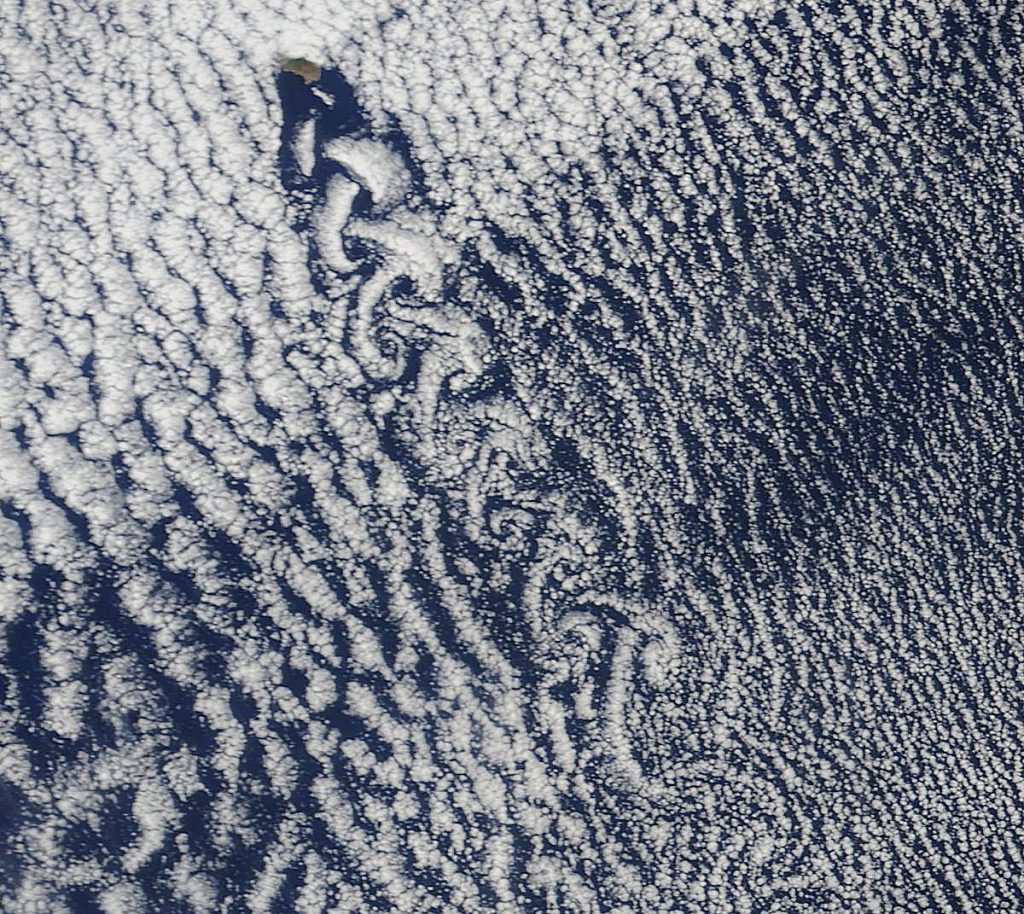 Scientific illustration: A satellite photo of clouds swirling into spirals.