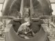 Scientific illustration of a worker manufacturing (or repairing) a gigantic Westinghouse engine (or generator).