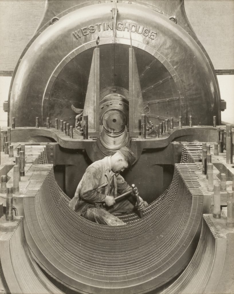 Scientific illustration of a worker manufacturing (or repairing) a gigantic Westinghouse engine (or generator).