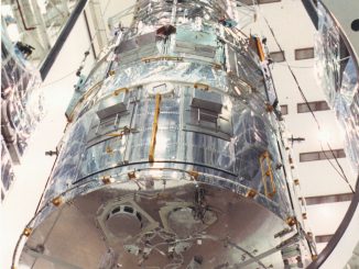 Scientific illustration of the Hubble Space Telescope being loaded into the gleaming VPF.