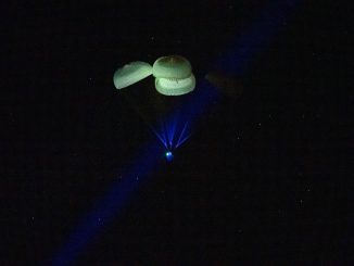 Scientific illustration of a space capsule landing on water, photographed by NASA/Keegan Barber.