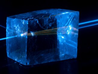 Scientific illustration by Jan Pavelka showing a blue laser creating a fluorescent glow inside a cube of calcite.