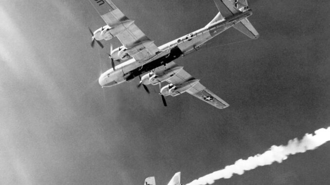 Scientific illustration of a supersonic rocket plane being launched from a bomber, a black-and-white photo of a shining steel dart leaving a trail of cloud beneath the massive shadow of its mothership.