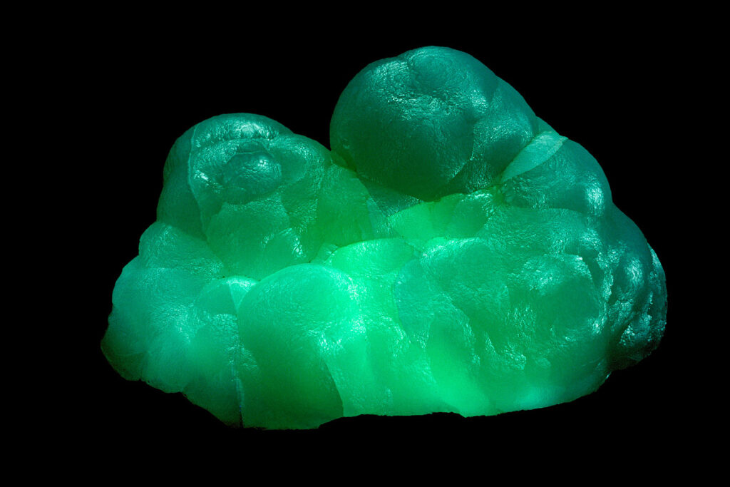 Scientific illustration of glowing minerals, green and crystalline.