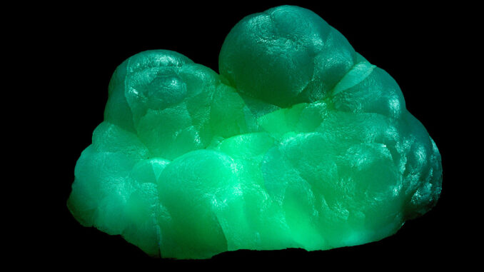Scientific illustration of glowing minerals, green and crystalline.