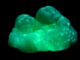 Scientific illustration of glowing minerals, green and crystalline.
