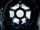 Scientific illustration of astronauts inside a replica of the International Space Station, a hexagonal window looking down on the Earth.