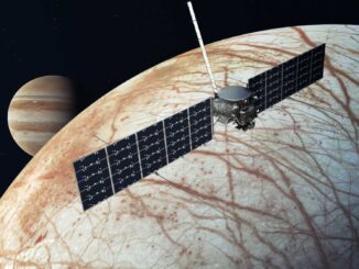 Scientific illustration of the Europa Clipper project, a satellite with long, rectangular solar-dell "wings" over the cris-crossed icy surface of Europa, the frozen moon of Jupiter.