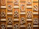 Scientific illustration in the form of a board on which rows of mathematical knots are mounted, complex geometries in loops of cord.