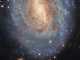 Scientific illustration of a spiral galaxy snapped by a space telescope, a yellow and blue spiral whirling against the blackness of space, with a bonus image of an asteroid moving much closer to Earth off to the right side, visible as four thin, colored lines: snapped when the telescope took four different colored exposures.