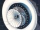 Scientific illustration of a space station from before rockets entered space, a white disk trailing cables like Lovecraftian tentacles, surrounding the reflective petals of a concave, segmented solar mirror.