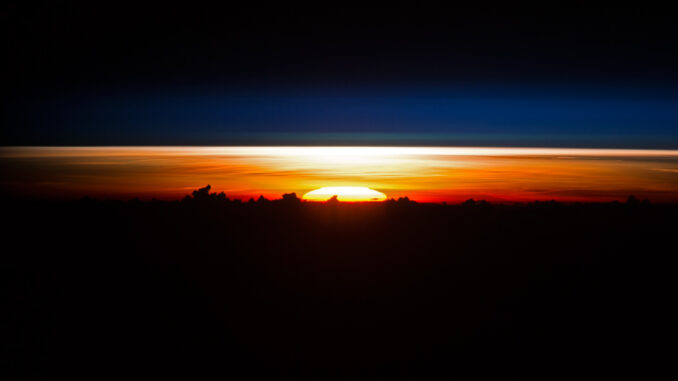 Scientific illustration of a sunrise seen from space, snapped by the astronauts aboard the International Space station orbiting over Vietnam.